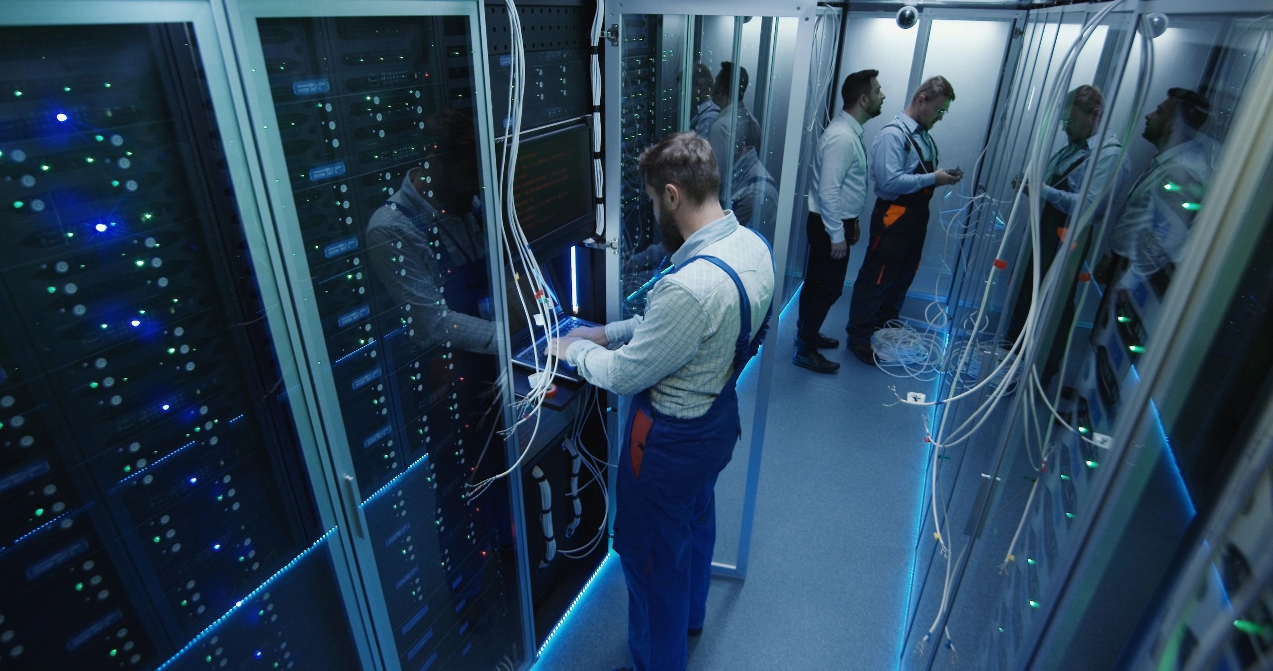 Engineers working in a data center server room