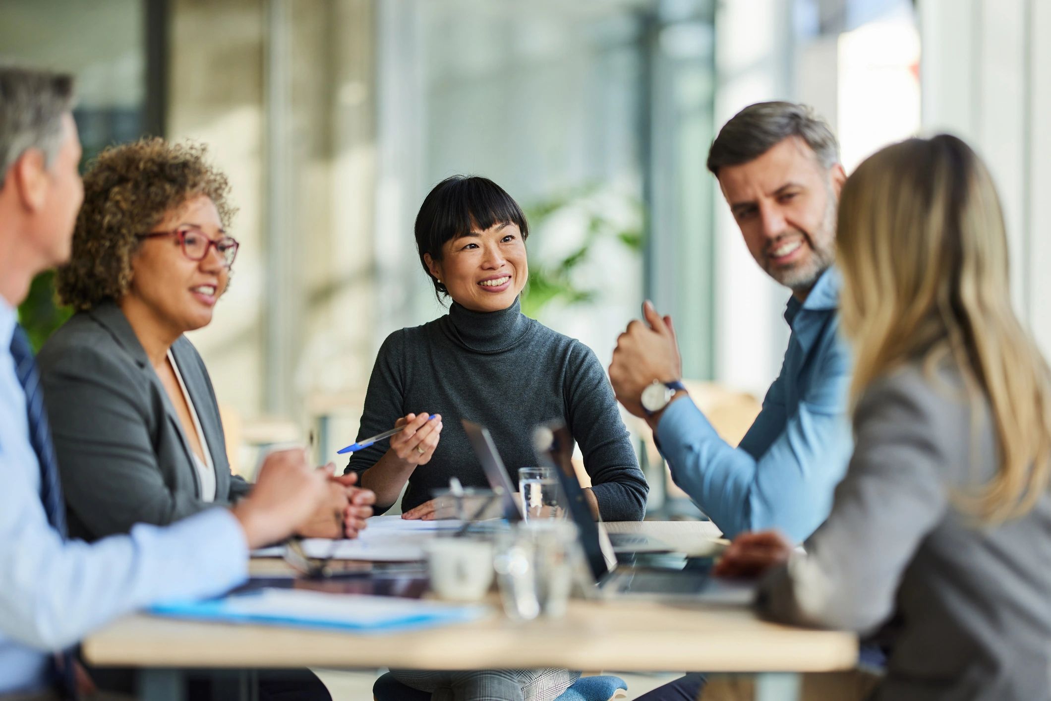 Happy multiracial business team collaborating in a modern office meeting